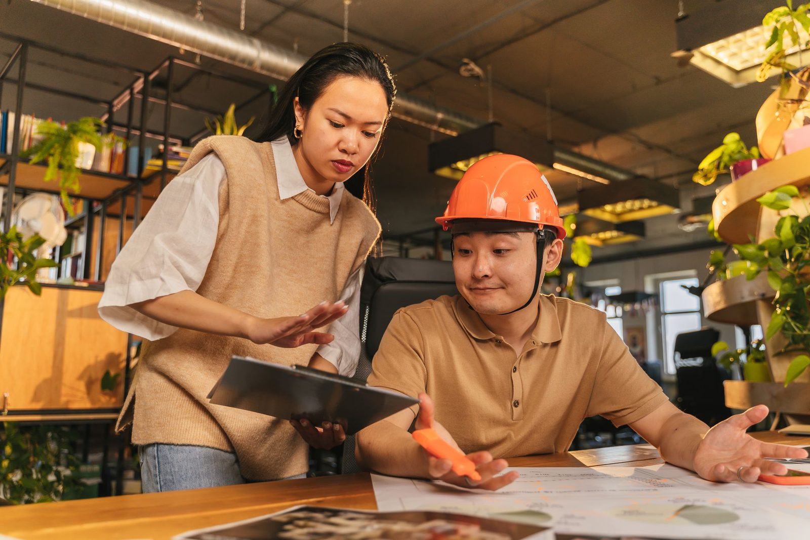Two consultants reviewing project drawings together